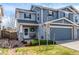 Attractive townhome with covered porch, stone accents, and well-manicured lawn at 6276 Turnstone Pl, Castle Rock, CO 80104
