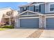 Charming two-story townhome featuring stone accents, a two-car garage, and well-maintained landscaping at 6276 Turnstone Pl, Castle Rock, CO 80104
