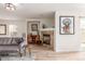 Bright living room featuring a stone fireplace, light wood floors, and comfortable seating at 6276 Turnstone Pl, Castle Rock, CO 80104