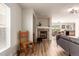 Bright and airy living room with wood floors, fireplace, and access to the dining area at 6276 Turnstone Pl, Castle Rock, CO 80104