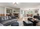 Open-concept living space featuring a cozy fireplace, wood floors, and adjacent dining area at 6276 Turnstone Pl, Castle Rock, CO 80104
