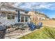 Back patio with ample seating, outdoor furniture, and a well-maintained lawn at 6276 Turnstone Pl, Castle Rock, CO 80104