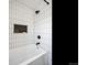 Shower and tub with white subway tile and a black shower head at 1705 S Downing St, Denver, CO 80210