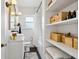 Updated bathroom featuring a modern vanity, black floors, and built-in shelving at 1705 S Downing St, Denver, CO 80210