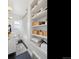 Updated bathroom featuring a modern vanity, black floors, and built-in shelving at 1705 S Downing St, Denver, CO 80210