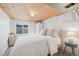 Cozy bedroom featuring natural wood ceiling, white walls, and warm natural light at 1705 S Downing St, Denver, CO 80210