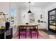 Bright dining space with a wooden table, modern chairs, and natural light from multiple windows at 1705 S Downing St, Denver, CO 80210