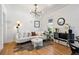 Bright living room with hardwood floors, stylish lighting, and a decorative leopard print rug at 1705 S Downing St, Denver, CO 80210