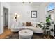 Cozy living room featuring a curved sofa, modern lighting, and a decorative leopard print rug at 1705 S Downing St, Denver, CO 80210