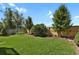 Green backyard featuring lush lawn, wood fence, mature trees and playground equipment at 20356 Willowbend Ln, Parker, CO 80138