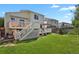 Spacious backyard with deck, patio, lush lawn, and charming two-story home at 20356 Willowbend Ln, Parker, CO 80138