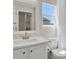 Well-lit bathroom featuring a white vanity, a toilet, and a shower with a bright window view at 20356 Willowbend Ln, Parker, CO 80138