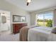 Bedroom featuring a large window, a view into the ensuite bathroom, and a dark wood dresser at 20356 Willowbend Ln, Parker, CO 80138