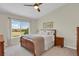 Comfortable bedroom featuring a wooden bed frame, neutral walls, and a large window with neighborhood views at 20356 Willowbend Ln, Parker, CO 80138