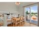 Cozy dining area with a stylish chandelier, view to the backyard, and laminate wood flooring at 20356 Willowbend Ln, Parker, CO 80138