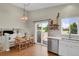 Cozy dining area with a stylish chandelier, view to the backyard, and laminate wood flooring at 20356 Willowbend Ln, Parker, CO 80138