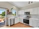 Well-lit kitchen with white cabinets, stainless steel appliances, and view to the patio at 20356 Willowbend Ln, Parker, CO 80138