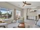 Bright living room featuring large windows, deck access, modern furnishings, and a loft-style upper level at 20356 Willowbend Ln, Parker, CO 80138