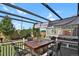 Patio area with dining table under a modern pergola and lush landscaping at 20356 Willowbend Ln, Parker, CO 80138
