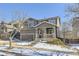 Two-story house with gray siding, red door, and a tree in the front yard at 10206 Sedalia St, Commerce City, CO 80022