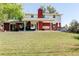 Spacious backyard featuring a patio, porch swing, and well-maintained lawn at 5332 W Roxbury Pl, Littleton, CO 80128