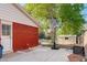 Backyard with a basketball hoop on a paved area and a small storage shed at 5332 W Roxbury Pl, Littleton, CO 80128