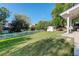 Expansive backyard featuring a well-manicured lawn, white picket fence, and a storage shed, ideal for outdoor enjoyment at 5332 W Roxbury Pl, Littleton, CO 80128