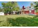 Large backyard featuring lawn, porch swing, patio set, and partial privacy fence at 5332 W Roxbury Pl, Littleton, CO 80128