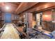 Finished basement with workout equipment, shuffle board, and exposed brick at 5332 W Roxbury Pl, Littleton, CO 80128
