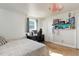Comfortable bedroom with a large bed, sliding door closet, modern ceiling fan and stylish furnishings at 5332 W Roxbury Pl, Littleton, CO 80128