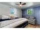 Cozy bedroom featuring accent wall, ceiling fan, and comfortable furniture at 5332 W Roxbury Pl, Littleton, CO 80128