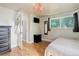 Well-lit bedroom featuring neutral decor, hardwood floors, and a window with a view of the outdoors at 5332 W Roxbury Pl, Littleton, CO 80128