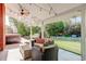 Stylish covered patio with comfortable seating, string lights, and a hot tub, creating a perfect outdoor space at 5332 W Roxbury Pl, Littleton, CO 80128