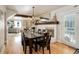 Elegant dining area with a dark wood table, chandelier, and a view into the living room at 5332 W Roxbury Pl, Littleton, CO 80128