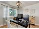 Home office with a modern desk, chair, curtains, light fixture, and decor at 5332 W Roxbury Pl, Littleton, CO 80128