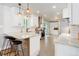 Bright kitchen with granite countertops, stainless steel appliances, and island with bar seating at 5332 W Roxbury Pl, Littleton, CO 80128