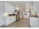 Spacious white kitchen with stainless steel appliances and hexagon tile flooring at 5332 W Roxbury Pl, Littleton, CO 80128