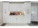 Kitchen bar area with custom cabinets, countertop, and door to the exterior at 5332 W Roxbury Pl, Littleton, CO 80128
