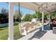Relaxing covered patio with a cozy porch swing, perfect for enjoying the outdoors and backyard views at 5332 W Roxbury Pl, Littleton, CO 80128