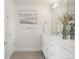 Bright bathroom featuring a double sink vanity with white cabinets, quartz countertops, and modern fixtures at 4006 Upham St, Wheat Ridge, CO 80033