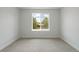 A cozy bedroom featuring soft carpeting, a bright window with outdoor views, and a clean, neutral color scheme at 4006 Upham St, Wheat Ridge, CO 80033