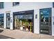 Exterior of a commercial building featuring an open garage door with plants and decor visible inside at 4006 Upham St, Wheat Ridge, CO 80033