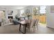Open-concept living space featuring dining area and living room with sliding door access to backyard at 4006 Upham St, Wheat Ridge, CO 80033