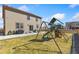 Backyard featuring a play set, lush grass, a patio, and grill at 567 Jewel St, Brighton, CO 80603