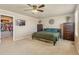 Bedroom with ensuite closet and a mounted tv over a queen bed at 567 Jewel St, Brighton, CO 80603