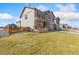 Two-story home featuring a two-car garage, with neutral exterior paint and an adjacent grass area at 567 Jewel St, Brighton, CO 80603