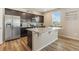 Spacious kitchen featuring a large island, stainless steel appliances, and dark wood cabinets at 567 Jewel St, Brighton, CO 80603