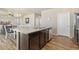 A kitchen island featuring a double sink and dark wood cabinets at 567 Jewel St, Brighton, CO 80603