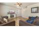 Comfortable living room featuring a fireplace, ceiling fan, wood floors, and multiple sofas at 567 Jewel St, Brighton, CO 80603