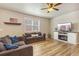 Inviting living room featuring a fireplace, wood floors, and cozy sofas at 567 Jewel St, Brighton, CO 80603